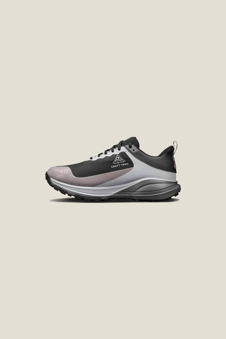 Gray and black athletic shoe on a beige background