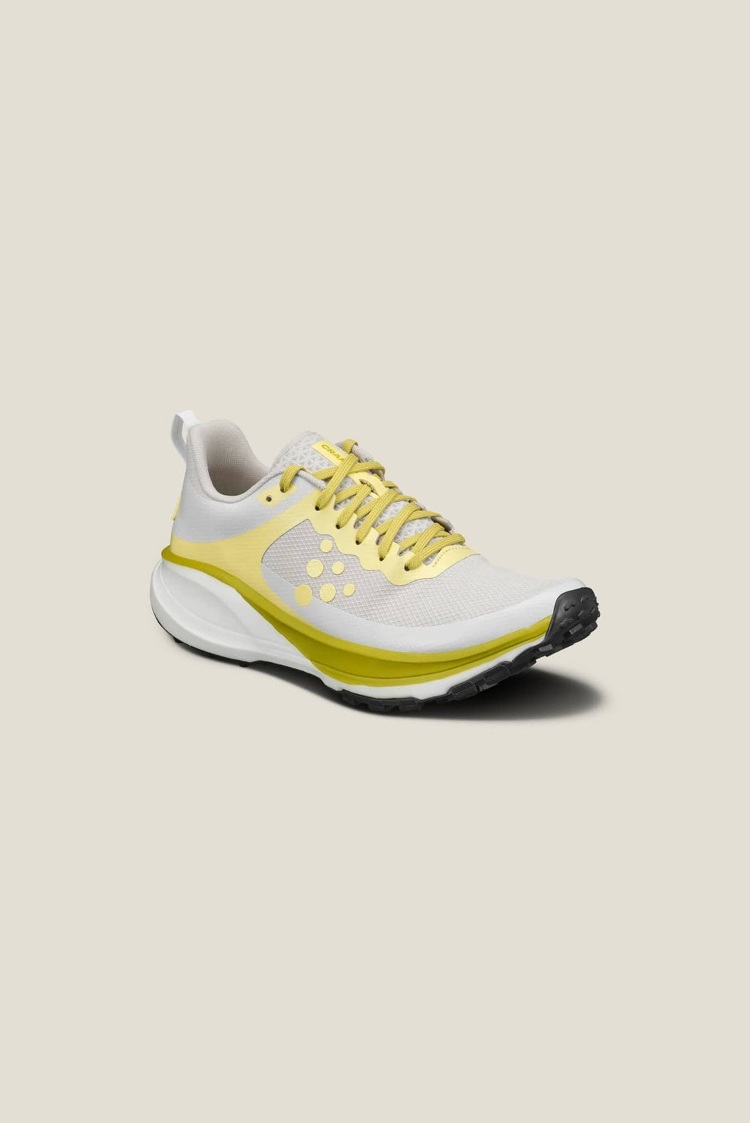 White and yellow running shoe on a beige background