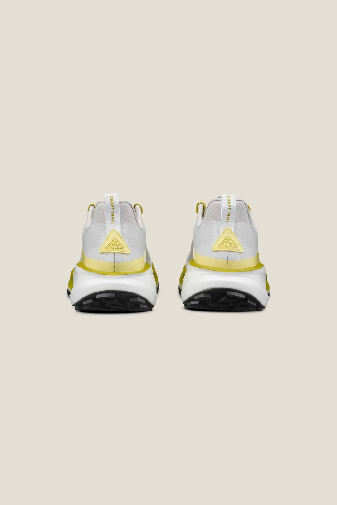 White sneakers with yellow accents on a beige background