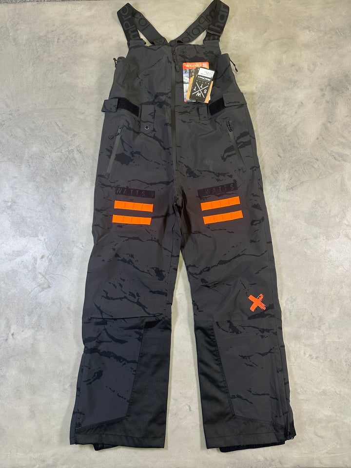WATTS Cork Bib Pants with waterproof breathable fabric, adjustable bib straps, reinforced lower legs, and snow gaiters.