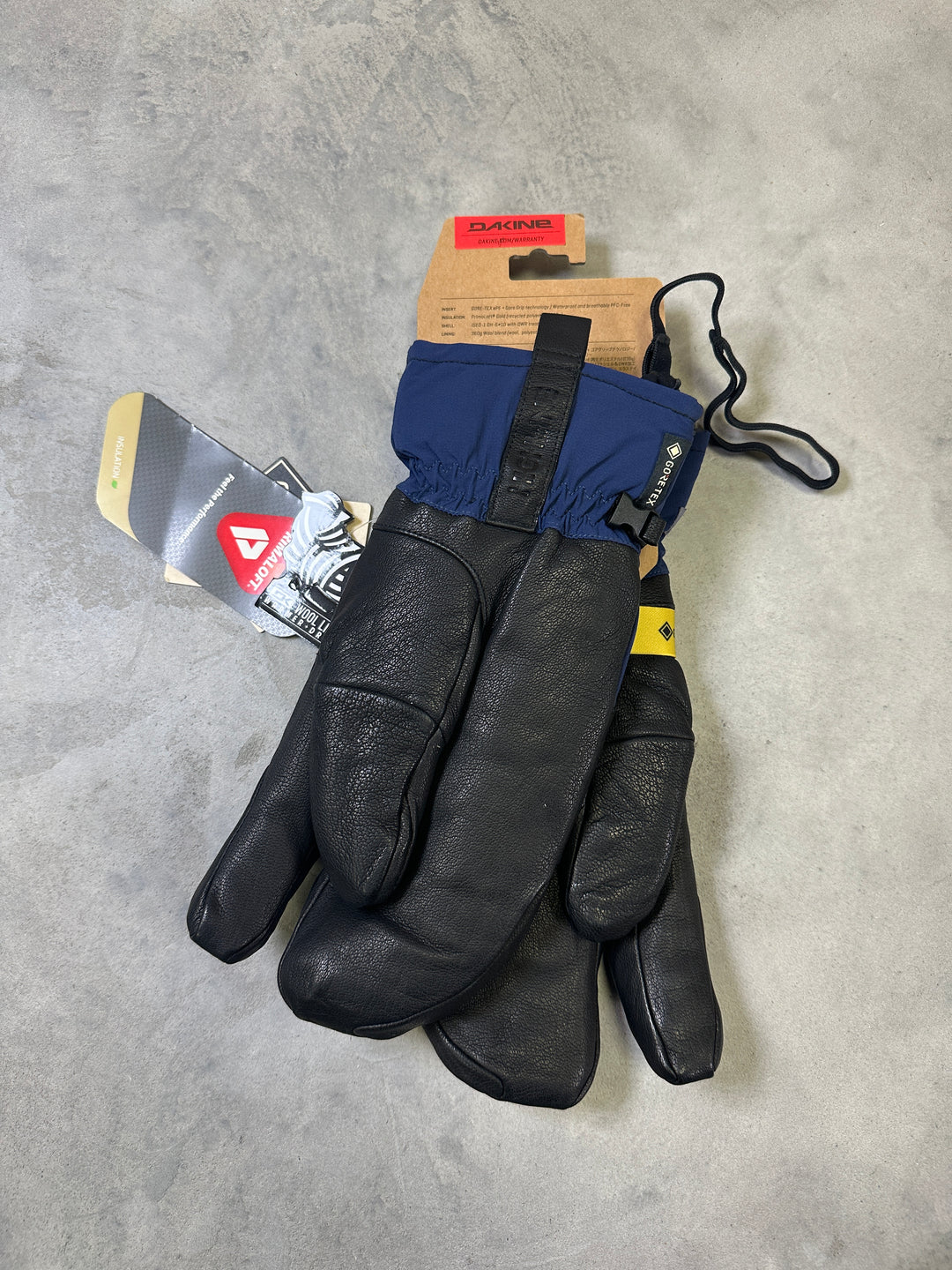 Dakine Baron GORE-TEX Trigger Mitts with waterproof membrane, leather palm, synthetic insulation, and trigger mitten design.