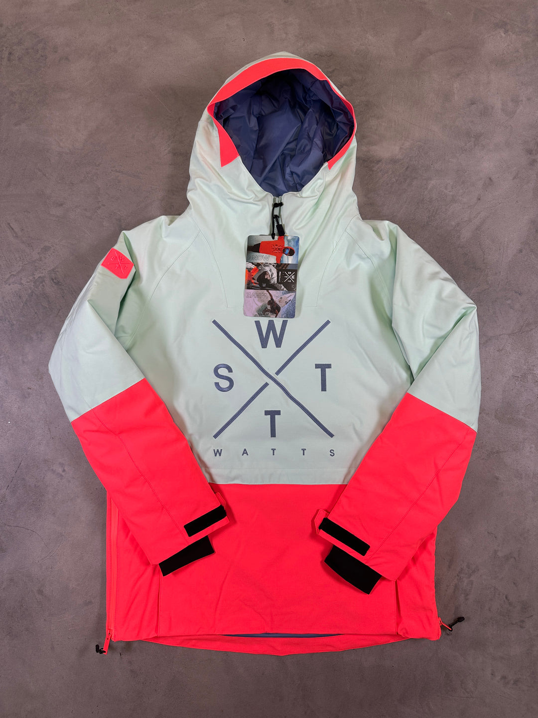 Color-blocked jacket with a brand logo on a gray surface