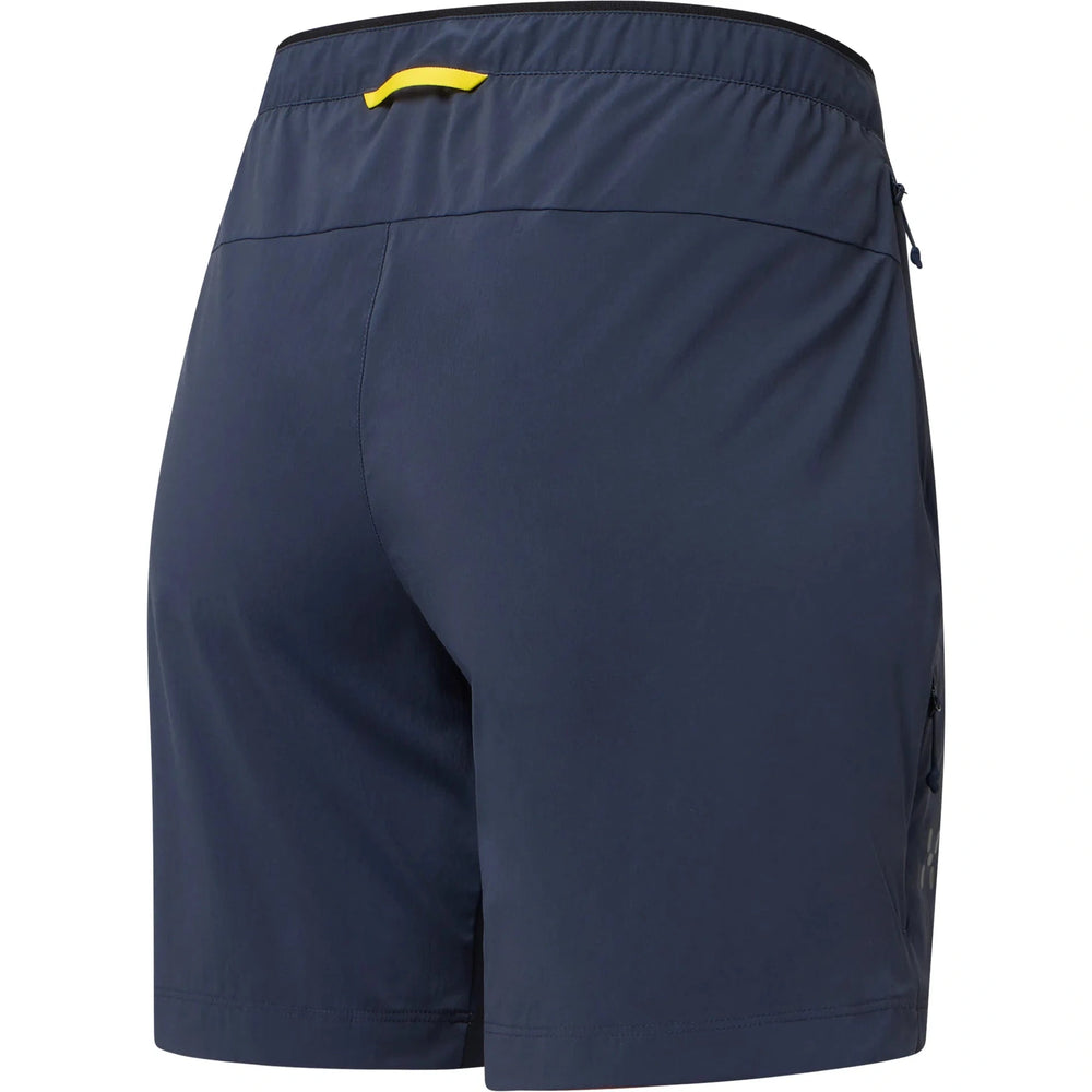 Navy blue shorts with a yellow waistband on a white background