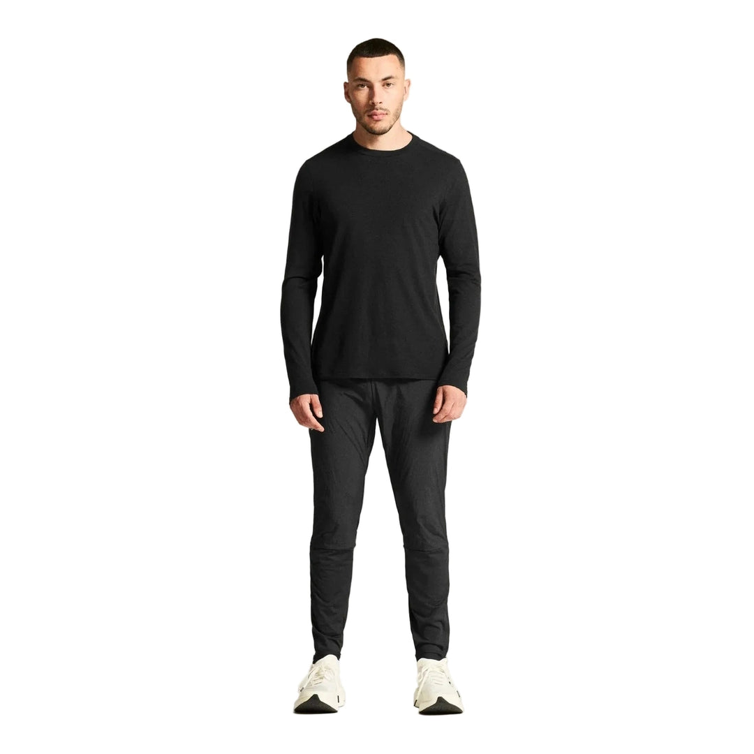 Athlete wearing Craft SubZ Light Pants Men Black during cold weather running