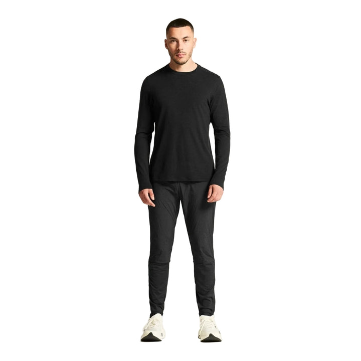 Athlete wearing Craft SubZ Light Pants Men Black during cold weather running