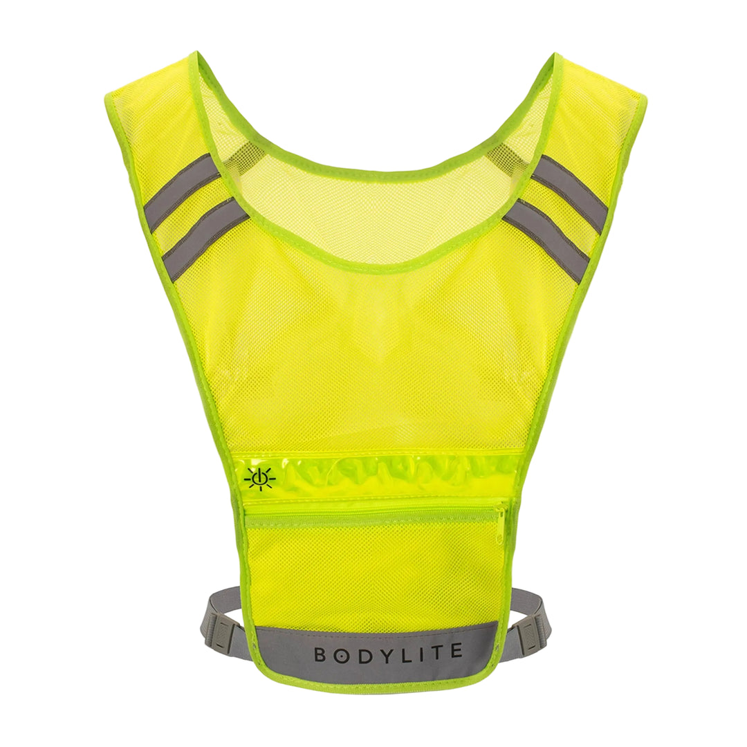 Yellow reflective running vest with gray straps on a light gray background